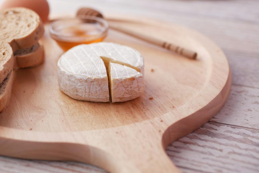 Verse Franse brie met witschimmel-korst geserveerd met honing en brood